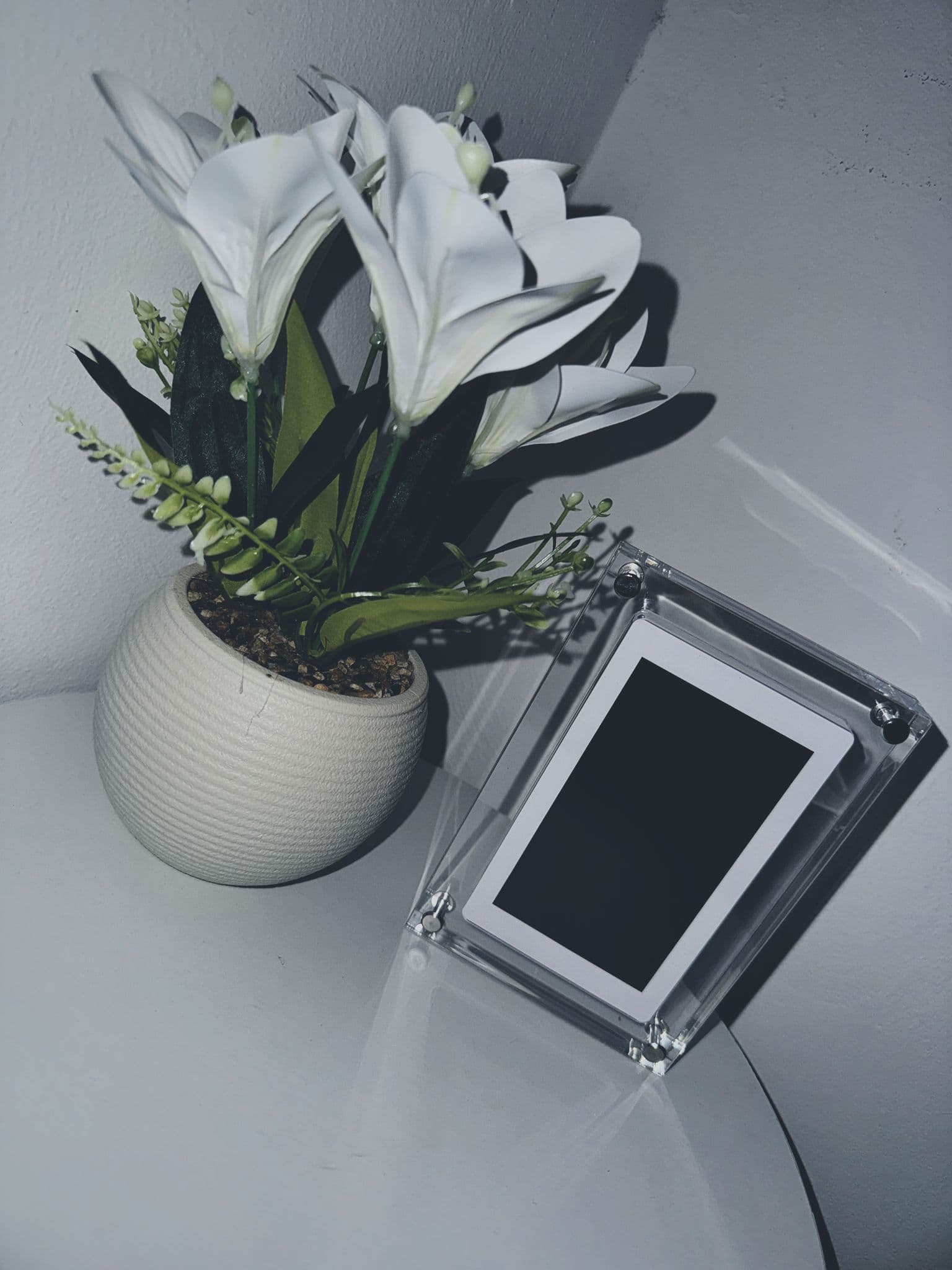 CoupleFrame — crystal acrylic frame on shelf