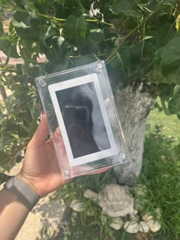 CoupleFrame — held in real life, outdoor garden setting